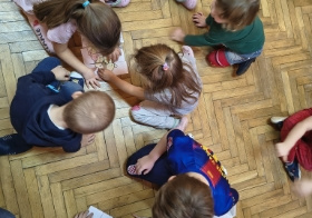 dzieci układają puzzle z misiem